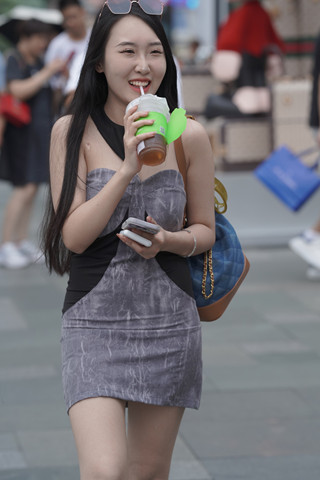 街拍喝饮料的短裙小姐姐
